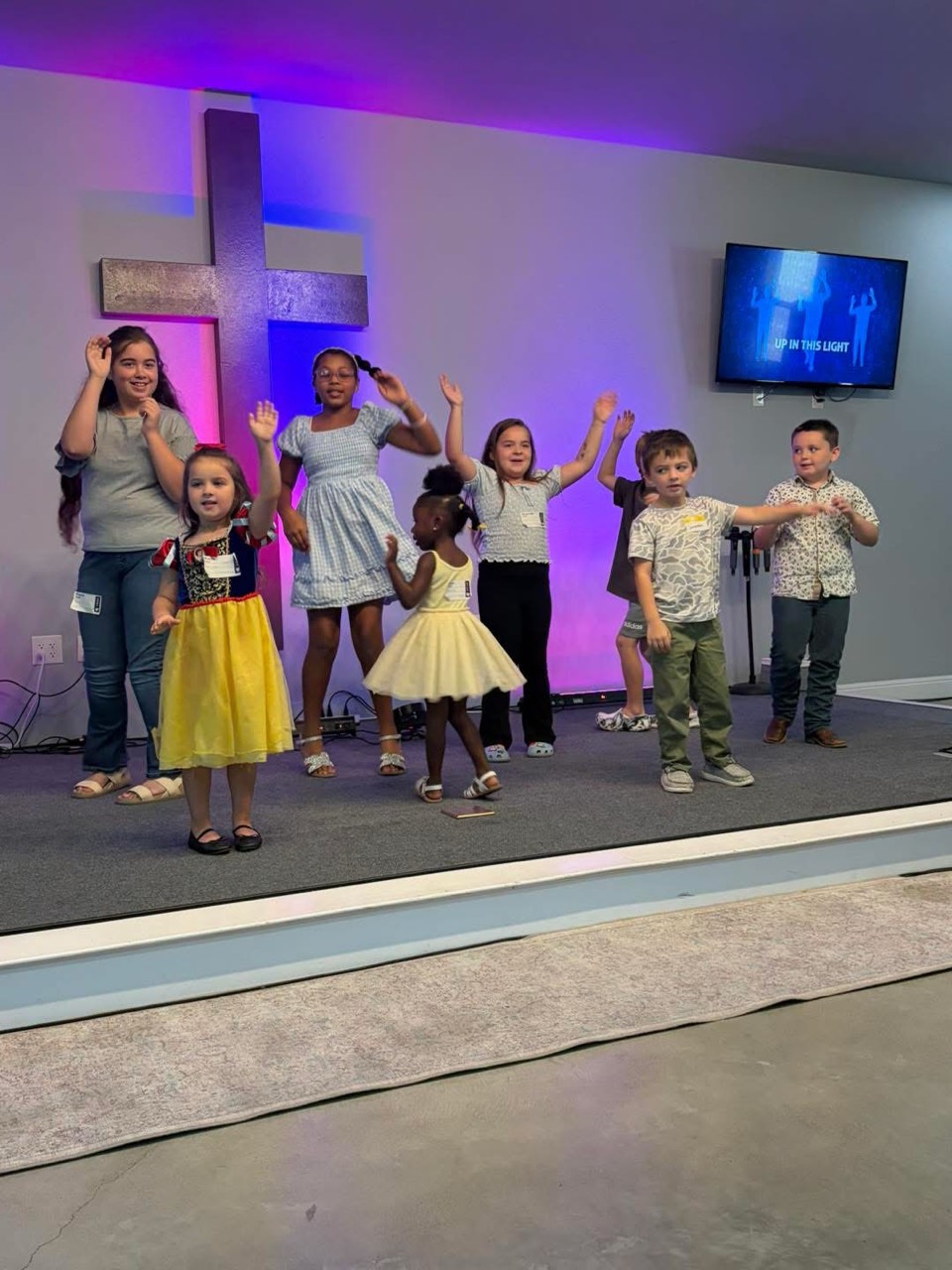 Children worshipping together on the church platform